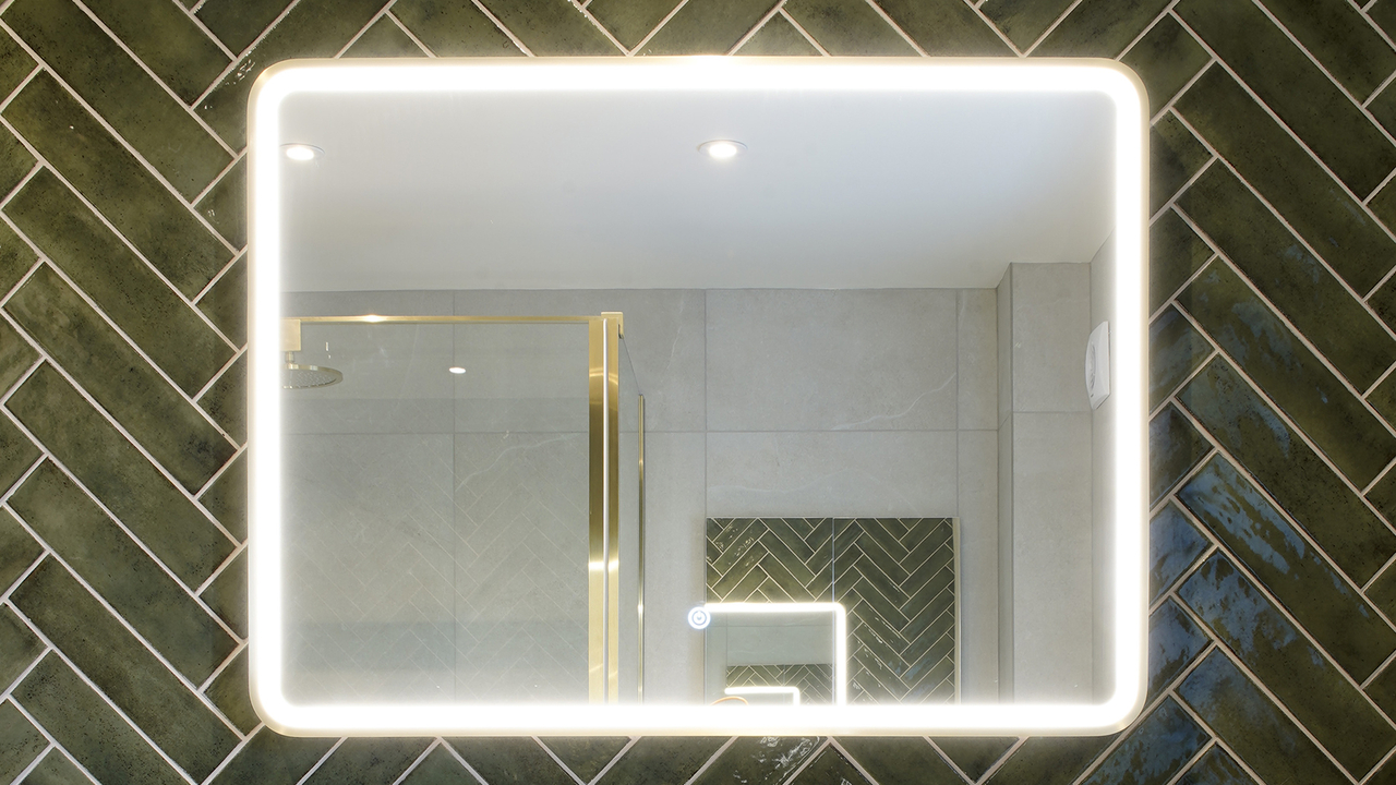 Green tiled bathroom light up mirror